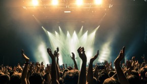 Concert-crowd-with-silhouettes-of-people-hold-their-hands-up