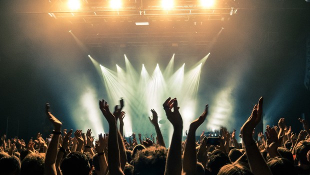 Concert-crowd-with-silhouettes-of-people-hold-their-hands-up